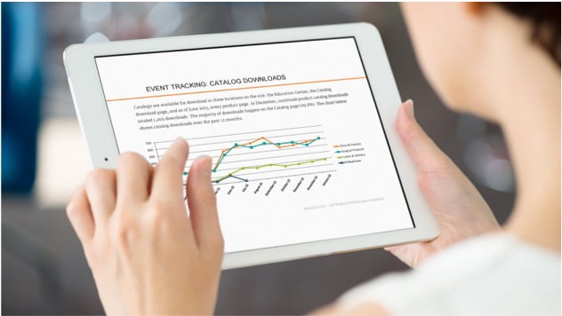 Woman looking at web reporting event tracking graph on Mobile tablet.