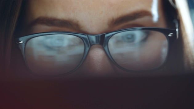 Close up of woman with black framed glasses